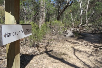 A sign indicating the direction to Hands on Rock - Mudgee
